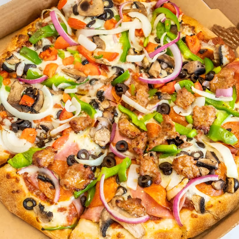 Antonious N&W Pizza's supreme pizza, loaded with sausage, pepperoni, ham, olives, onions, peppers, and mushrooms.