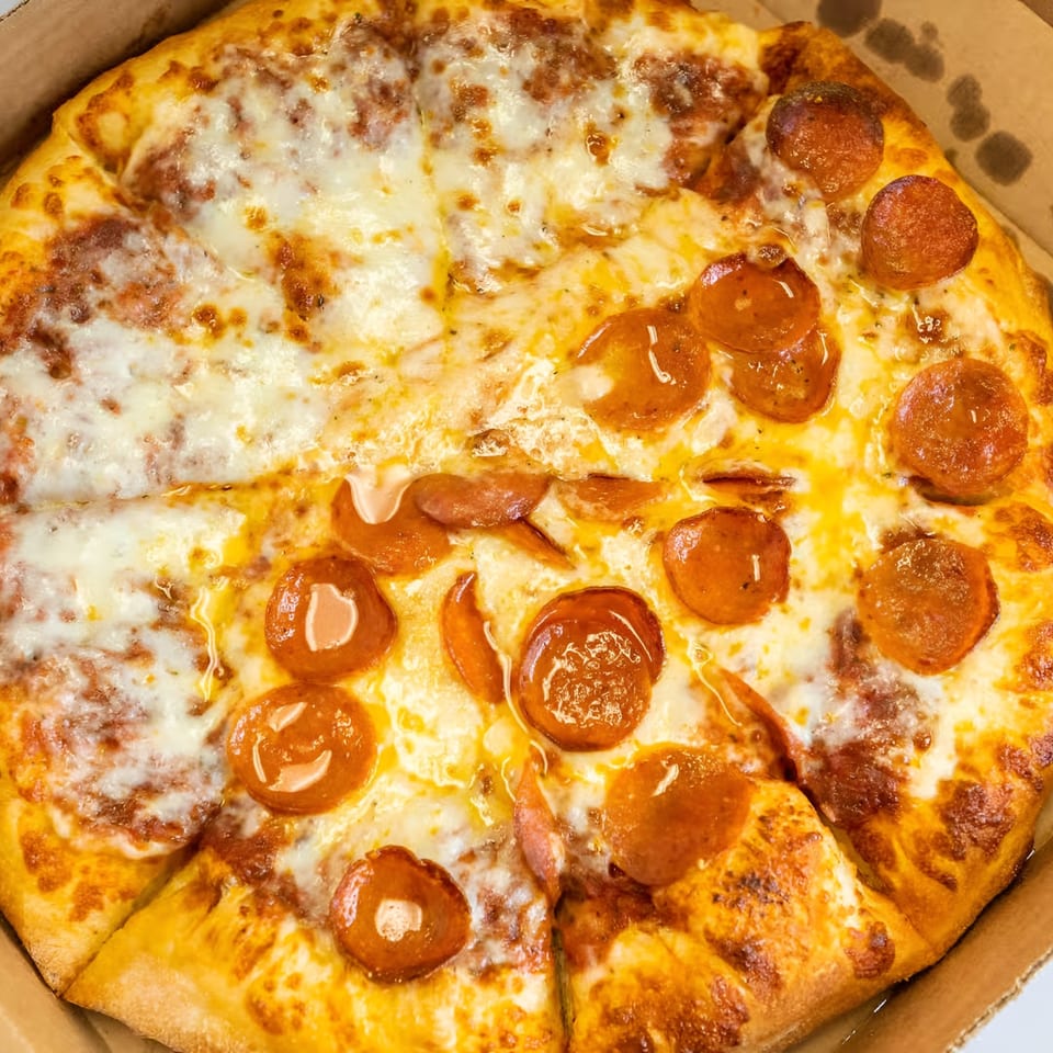 Antonious N&W Pizza's half cheese, half pepperoni pizza in a cardboard box.